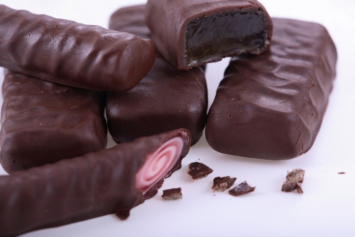 Chocolate covered candies with jelly and swirl filling
