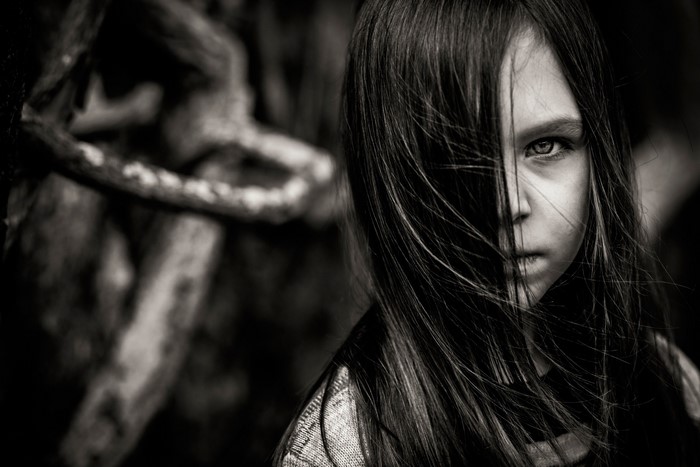 Girl with hair covering face looking at camera