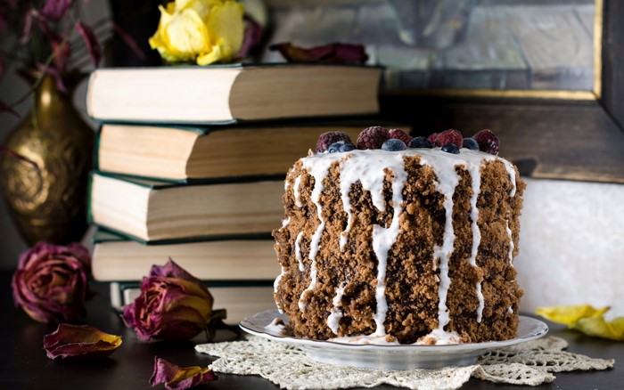 Chocolate cake with berries and books