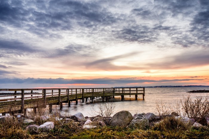 Wooden pier on the coast at sunset