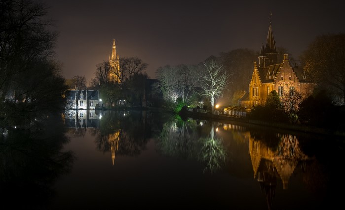 Bruges canal at night with illuminated buildings and reflections