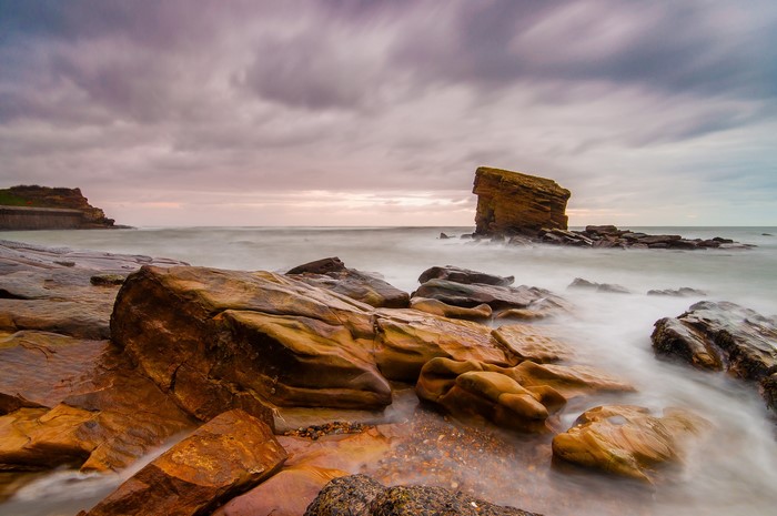 Rocky coast with waves and dramatic clouds