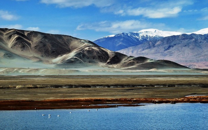 Pamir Mountains with a lake and birds