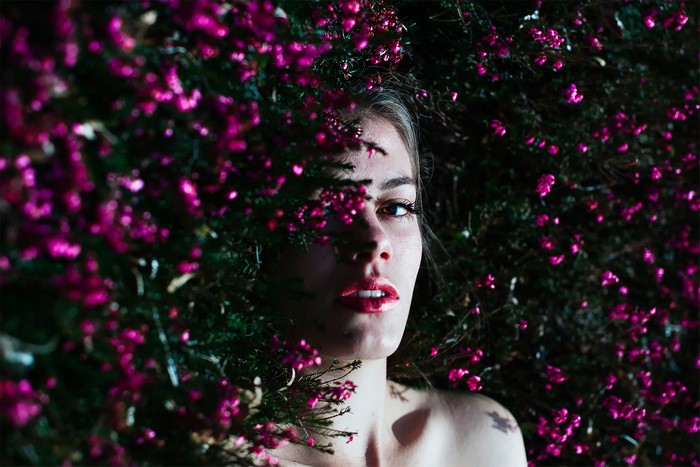 Woman lying in pink flowers