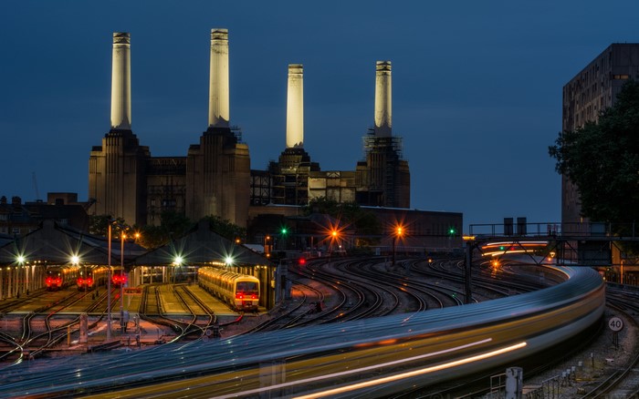 Battersea Power Station at night with trains