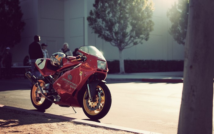 Red Ducati Supersport 900 motorcycle with helmet