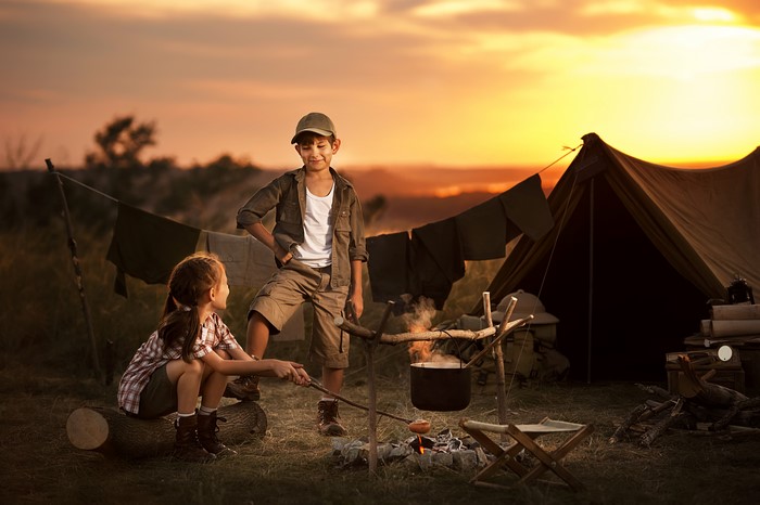 Children camping at sunset