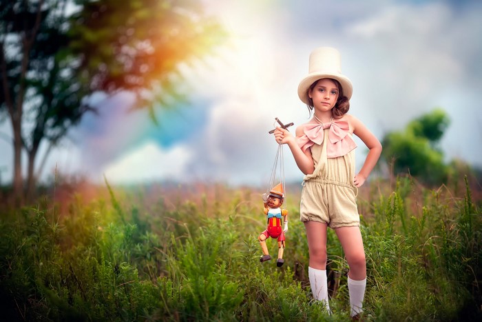 Girl in Top Hat Holding Pinocchio Puppet