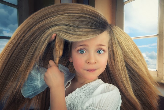 Girl with extremely long blonde hair and a comb