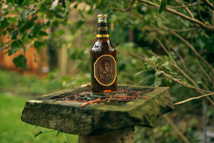 Burns Ale bottle on a stone pedestal
