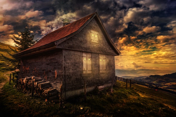 Wooden house on a hill at sunset, Switzerland