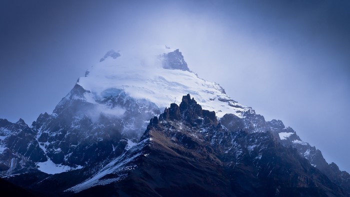 Snow-capped mountains shrouded in mist
