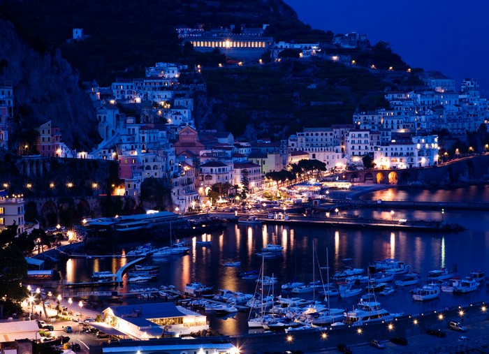 Amalfi Coast town at night with marina