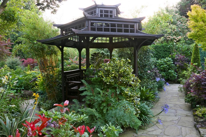 Garden with a wooden pagoda and diverse plants