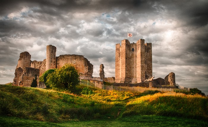 Conisbrough Castle ruins in the United Kingdom under a cloudy sky