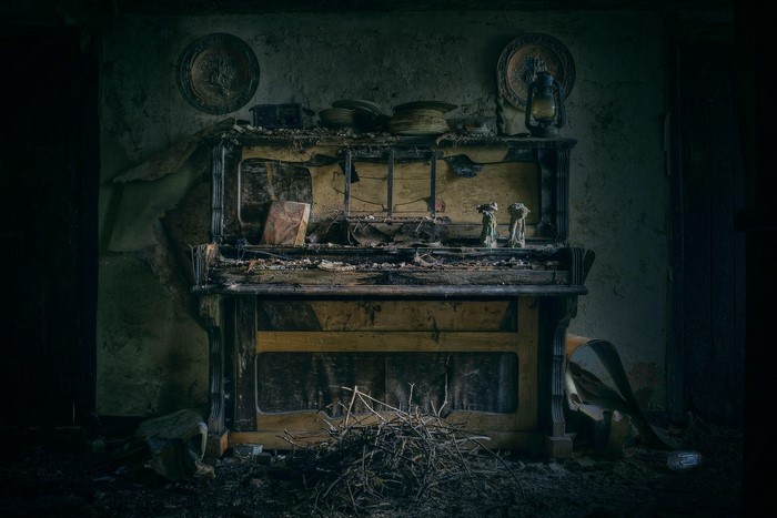 Abandoned piano in a derelict room