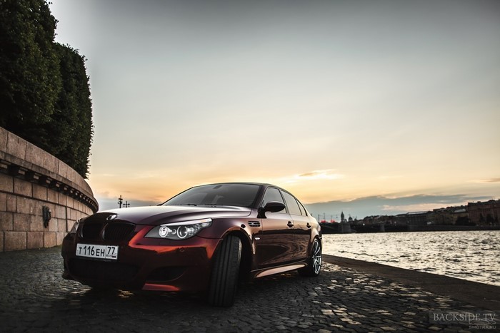 Red BMW E60 M5 Sedan on Cobblestone Street