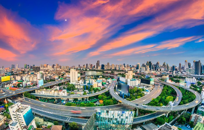 Bangkok cityscape with highway interchange at sunset