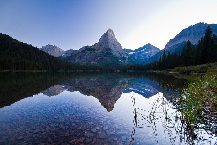 Lake reflection of mountains and forest
