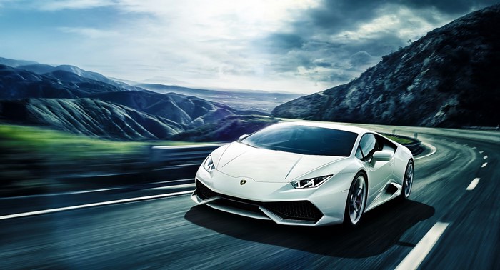 White Lamborghini Huracan LP640-4 driving on a mountain road