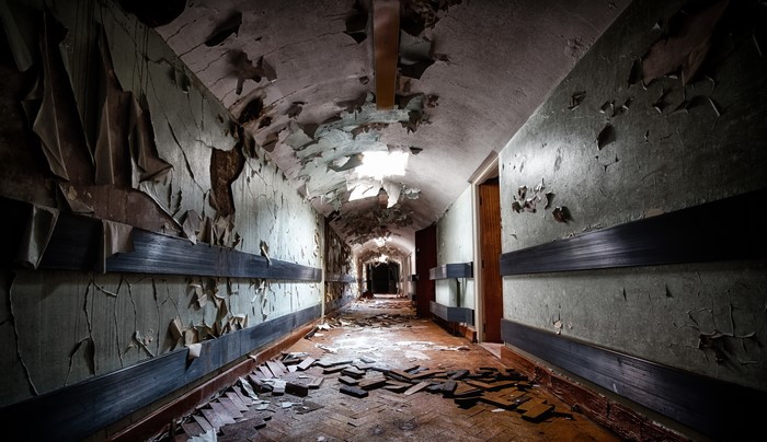 Abandoned hallway corridor with peeling paint