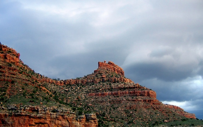 Red rock formations under a cloudy sky