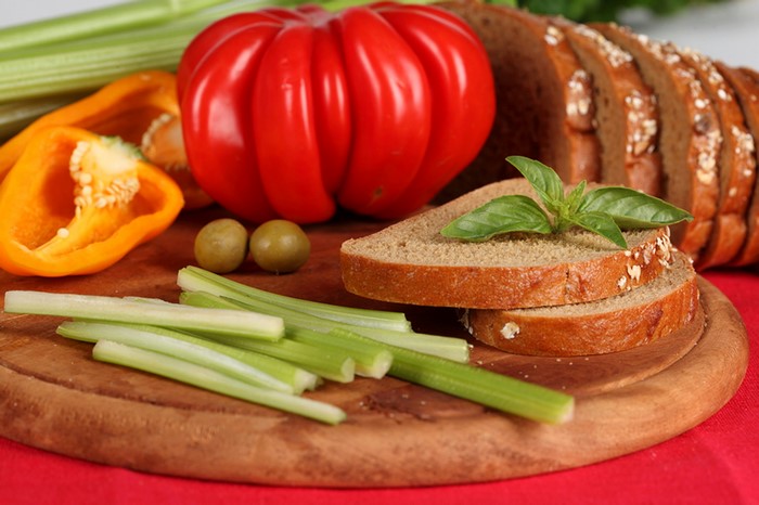 Still-life with bread, tomato, bell pepper, celery, and olives