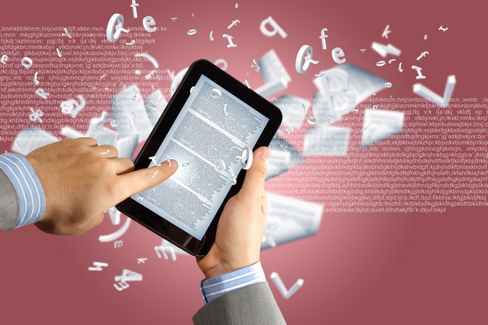 4K Tablet computer with hands and floating letters
