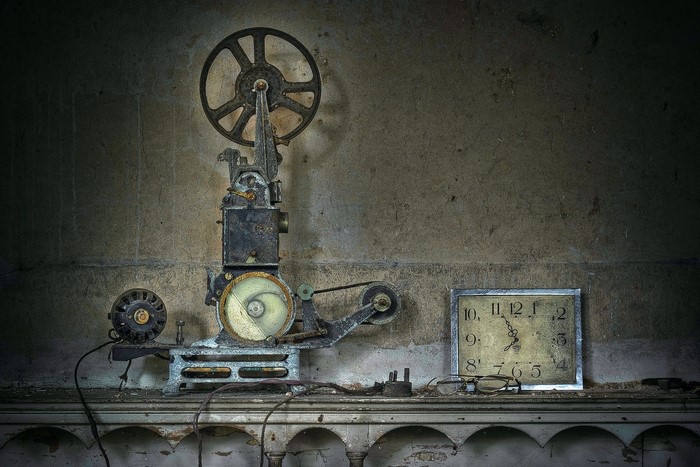 Old film projector and clock on a shelf