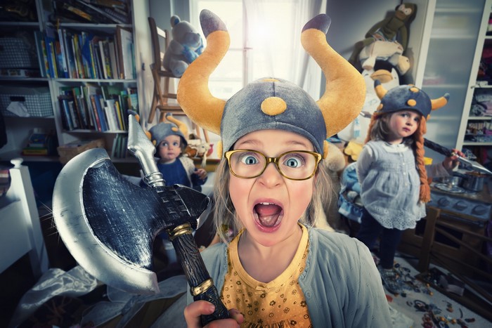 Girls in Viking Helmets with Toy Axes in Messy Room