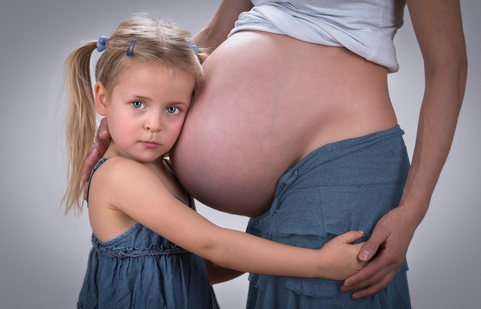 Pregnant woman and young daughter