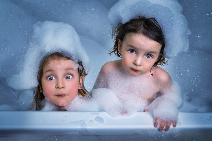 Two sisters in a bubble bath