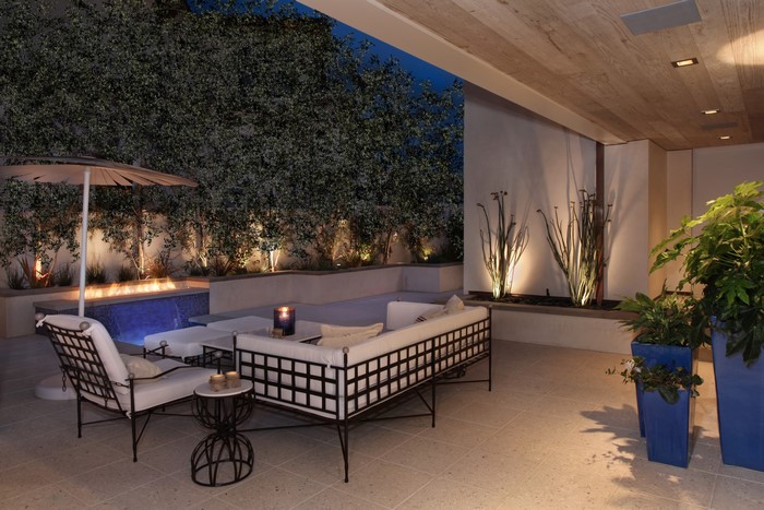 Outdoor Patio with Fireplace and Seating at Night