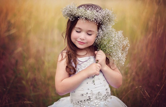 Little girl with flower crown and bouquet