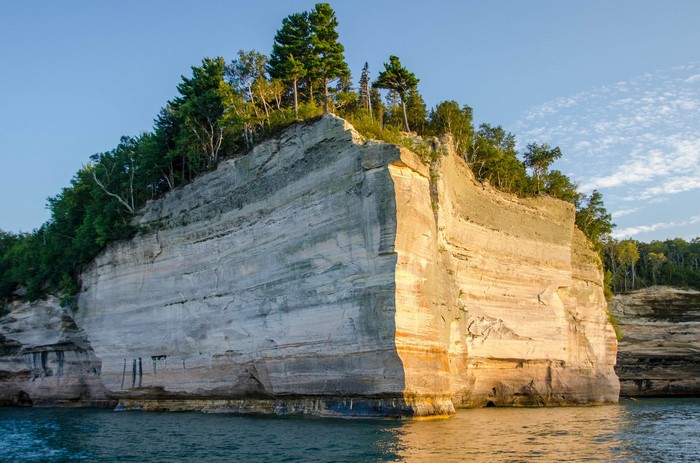 Cliff face with trees and water