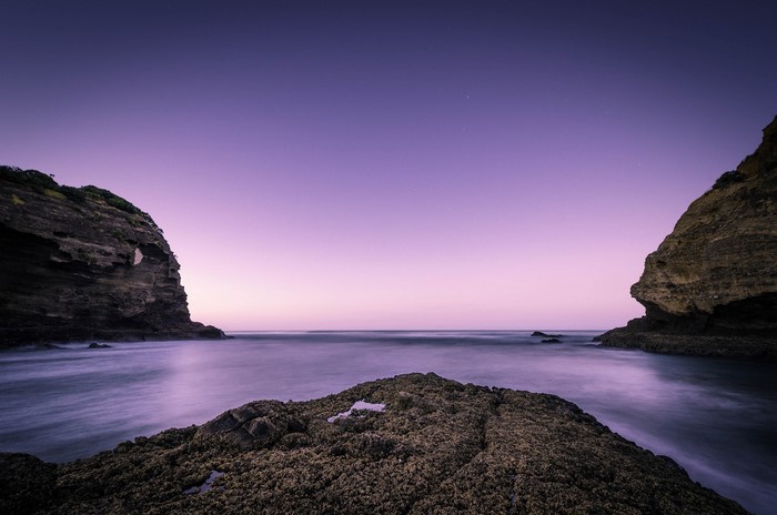 Rocky coast and sea at twilight in New Zealand