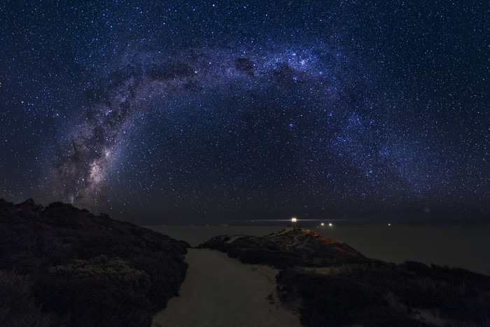 Milky Way over a coastal landscape at night