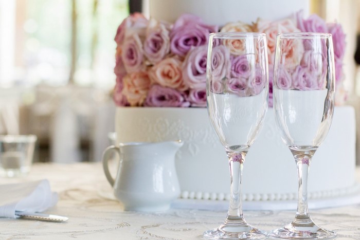 Wedding cake with champagne glasses and flowers