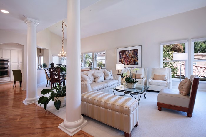 Living room with sofa, armchairs, and dining area