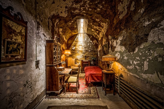Prison cell with antique furniture and lamps