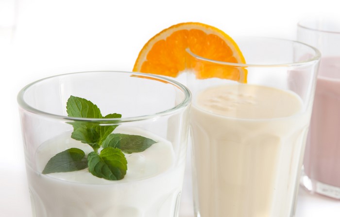 Three glasses of drinks with orange and mint