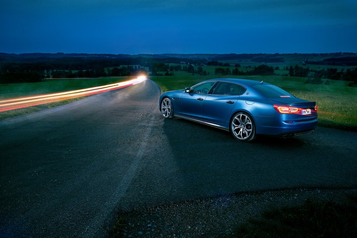 Blue Maserati Quattroporte Novitec on a road at night