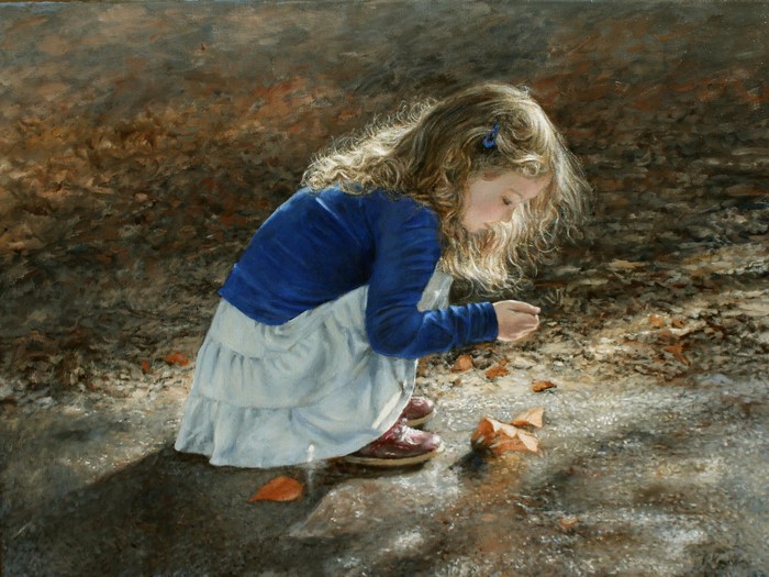 Girl in blue sweater looking at leaves