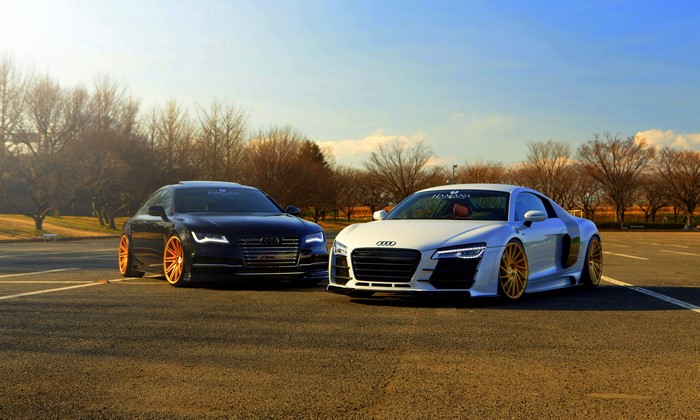 Two Audi cars, R8 and A7, parked outdoors