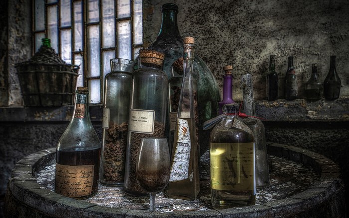 Old bottles and stemware on a barrel