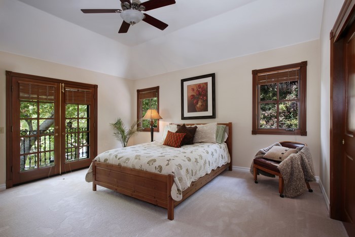 Bedroom with wooden bed and French doors
