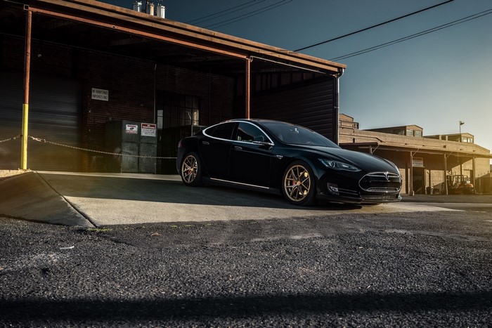 Black Tesla Model S P85 parked in a garage