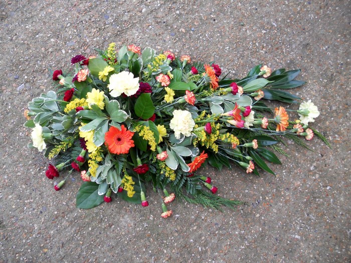 Funeral flower arrangement with gerberas and carnations