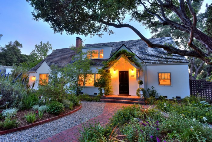 House with garden and trees at dusk