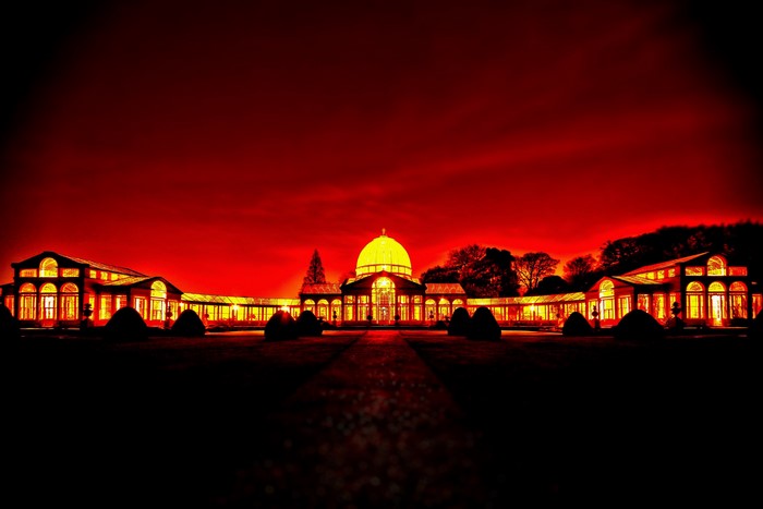 Glasshouse building with dome at night